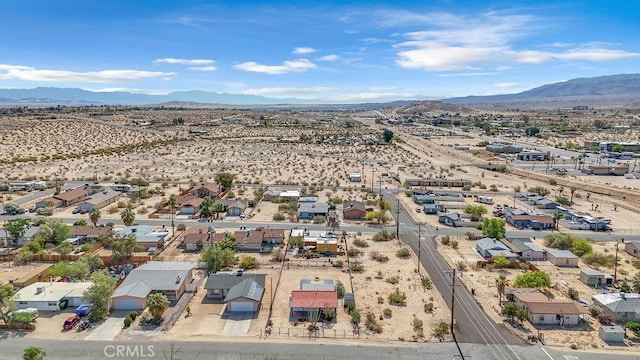 6365 Cahuilla Ave Unit 29, Palms, CA 92277 - aerial perspective of suburban area featuring a mountainous background and a desert landscape