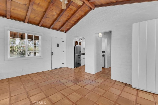 6365 Cahuilla Ave Unit 29, Palms, CA 92277 - spare room featuring wooden ceiling with exposed beams, light tile patterned flooring, high vaulted ceiling, and arched walkways