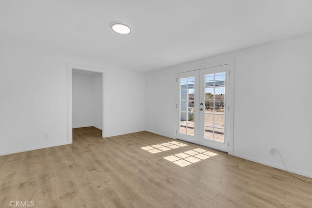 6365 Cahuilla Ave Unit 29, Palms, CA 92277 - spare room with french doors, light wood-style flooring, and baseboards