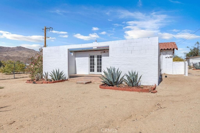 6365 Cahuilla Ave Unit 29, Palms, CA 92277 - rear view of property featuring french doors and a mountain view