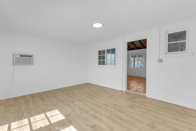 6365 Cahuilla Ave Unit 29, Palms, CA 92277 - spare room with wood finished floors and an AC wall unit