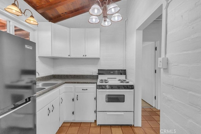 6365 Cahuilla Ave Unit 29, Palms, CA 92277 - kitchen featuring freestanding refrigerator, white range with gas cooktop, wooden ceiling, a sink, and light tile patterned floors