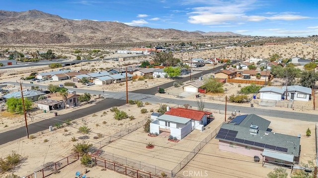 6365 Cahuilla Ave Unit 29, Palms, CA 92277 - aerial perspective of suburban area featuring a mountain backdrop and a desert landscape