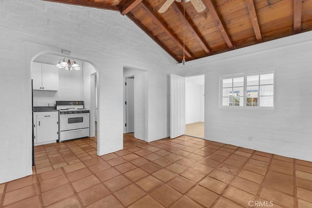 6365 Cahuilla Ave Unit 29, Palms, CA 92277 - unfurnished living room featuring wooden ceiling with exposed beams, high vaulted ceiling, arched walkways, a chandelier, and light tile patterned floors