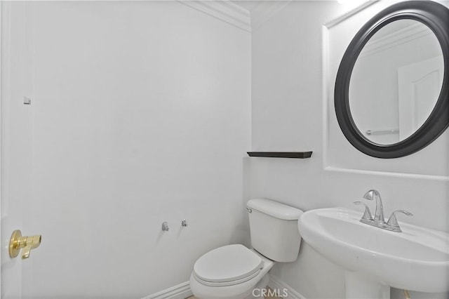 5840 Redhaven St, Eastvale, CA 92880 - bathroom with baseboards, toilet, ornamental molding, and a sink