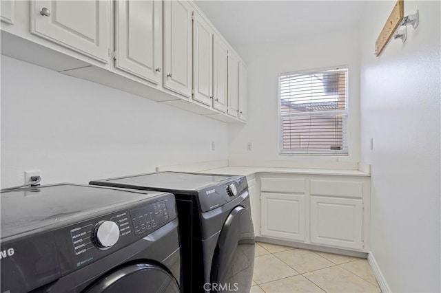 5840 Redhaven St, Eastvale, CA 92880 - laundry room featuring washer and clothes dryer, cabinet space, light tile patterned floors, and baseboards