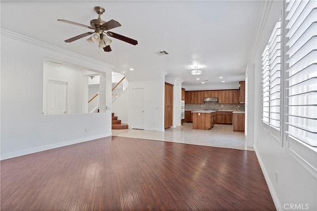 5840 Redhaven St, Eastvale, CA 92880 - unfurnished living room featuring baseboards, light wood-style flooring, ceiling fan, crown molding, and recessed lighting