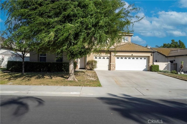 5840 Redhaven St, Eastvale, CA 92880 - view of front facade featuring driveway, stucco siding, and an attached garage