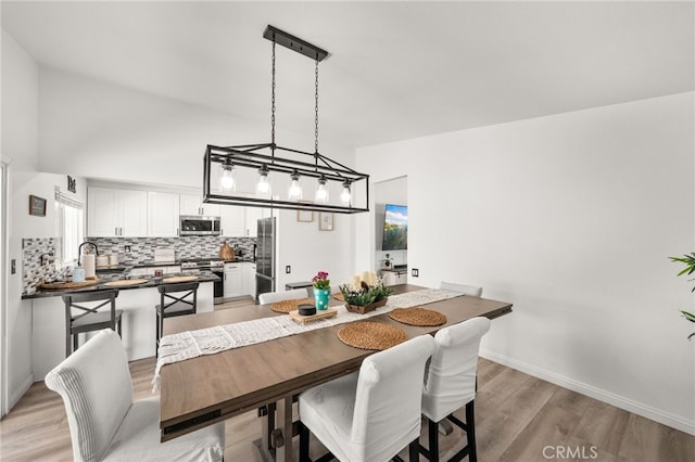 1138 Millstream Ln, Corona, CA 92878 - dining space with light wood finished floors, baseboards, and lofted ceiling