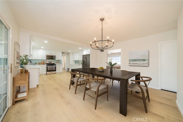 25810 San Felipe Dr, Hemet, CA 92544 - dining space featuring light wood-style floors, a chandelier, recessed lighting, and baseboards