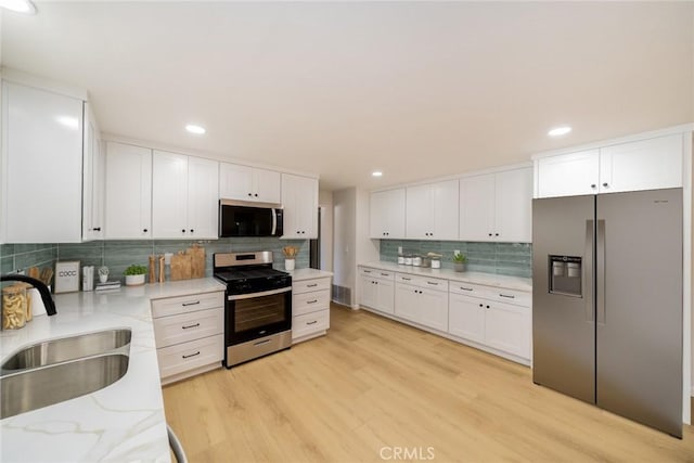25810 San Felipe Dr, Hemet, CA 92544 - kitchen with stainless steel appliances, a sink, tasteful backsplash, white cabinetry, and recessed lighting
