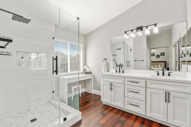 8550 Alexandria St, Riverside, CA 92508 - full bathroom featuring a stall shower, double vanity, a ceiling fan, wood finished floors, and baseboards