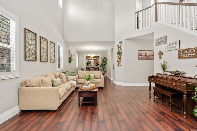 8550 Alexandria St, Riverside, CA 92508 - living room featuring a chandelier, dark wood-style flooring, baseboards, plenty of natural light, and a towering ceiling