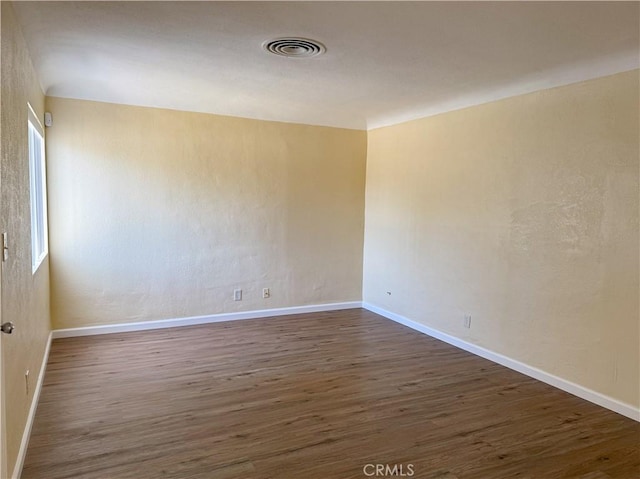 812 Wilson Ave, Bakersfield, CA 93308 - spare room with wood finished floors and baseboards