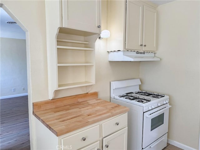812 Wilson Ave, Bakersfield, CA 93308 - kitchen featuring white range with gas cooktop, wooden counters, under cabinet range hood, and white cabinets