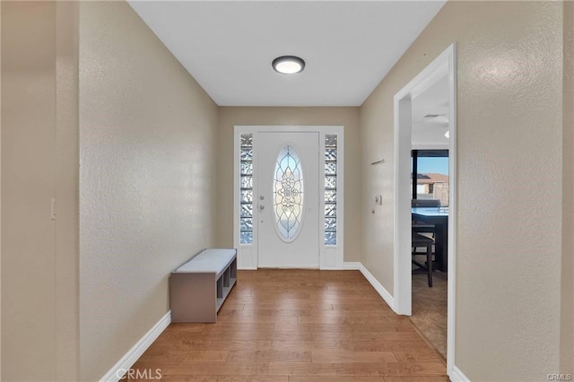 19055 Seaforth St, Hesperia, CA 92345 - foyer entrance featuring light wood-style floors, a textured wall, and baseboards