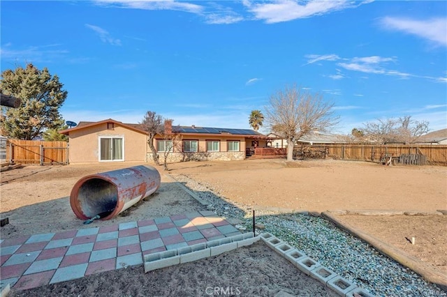 19055 Seaforth St, Hesperia, CA 92345 - back of house featuring roof mounted solar panels and a fenced backyard