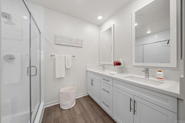3001 Bravo Loop Unit 1, Chula Vista, CA 91915 - bathroom featuring double vanity, wood finished floors, a stall shower, baseboards, and recessed lighting