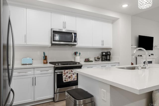 3001 Bravo Loop Unit 1, Chula Vista, CA 91915 - kitchen featuring stainless steel appliances, a sink, light countertops, white cabinets, and recessed lighting