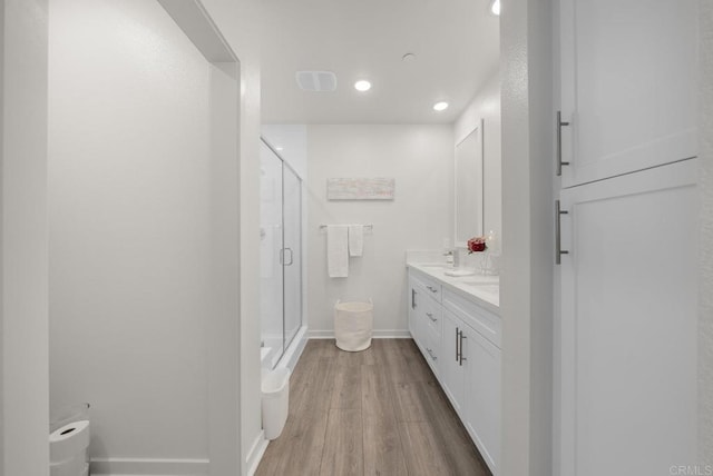 3001 Bravo Loop Unit 1, Chula Vista, CA 91915 - bathroom with a stall shower, double vanity, wood finished floors, baseboards, and recessed lighting