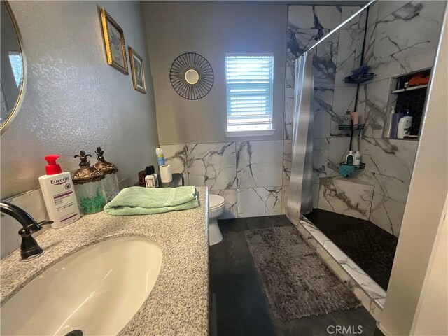 31728 Pompei Ln, Winchester, CA 92596 - bathroom featuring toilet, a marble finish shower, tile walls, and vanity