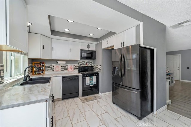 12241 Carnation Unit B, Moreno Valley, CA 92557 - kitchen with black appliances, a sink, white cabinetry, tasteful backsplash, and baseboards