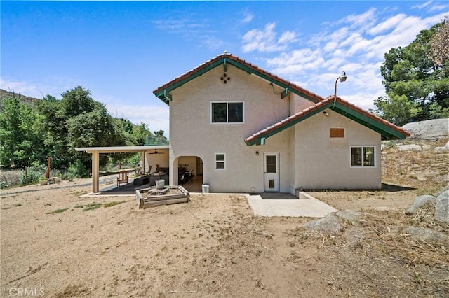 40901 Gibbel Rd, Hemet, CA 92544 - back of house featuring stucco siding, a patio area, a ceiling fan, and a tile roof