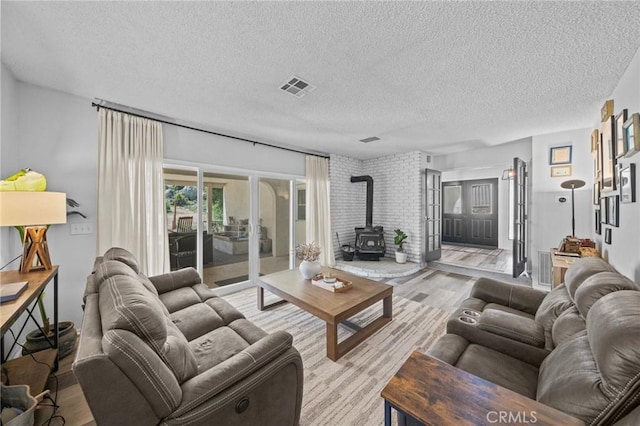 40901 Gibbel Rd, Hemet, CA 92544 - living area with a wood stove, light wood-type flooring, a textured ceiling, and french doors