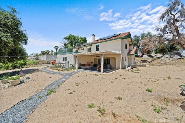 40901 Gibbel Rd, Hemet, CA 92544 - rear view of property with a ceiling fan, a patio area, solar panels, stucco siding, and a chimney