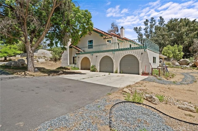 40901 Gibbel Rd, Hemet, CA 92544 - mediterranean / spanish house with a balcony, an attached garage, driveway, and stucco siding