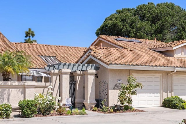15746 Via Calanova, San Diego, CA 92128 - view of front facade with an attached garage, solar panels, a tiled roof, stucco siding, and a pergola