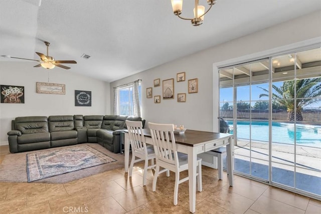 17660 Seaforth St, Hesperia, CA 92345 - tiled dining room featuring vaulted ceiling, ceiling fan, and a chandelier