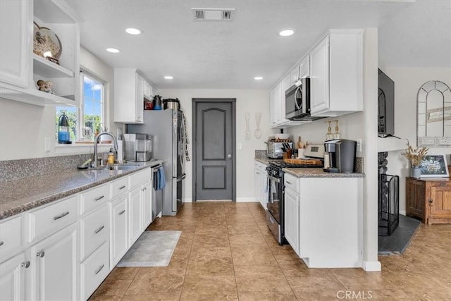 17660 Seaforth St, Hesperia, CA 92345 - kitchen featuring appliances with stainless steel finishes, white cabinets, recessed lighting, light tile patterned floors, and light stone countertops