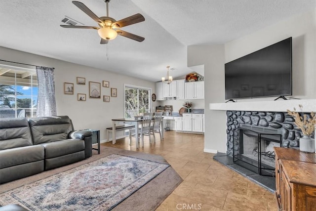 17660 Seaforth St, Hesperia, CA 92345 - living area with ceiling fan, a textured ceiling, and a fireplace