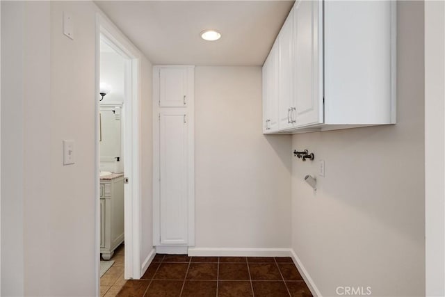 20310 Anza Ave Unit O, Torrance, CA 90503 - washroom with baseboards, dark tile patterned floors, and cabinet space