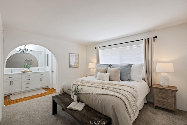 20310 Anza Ave Unit O, Torrance, CA 90503 - bedroom with light carpet, arched walkways, a sink, and connected bathroom