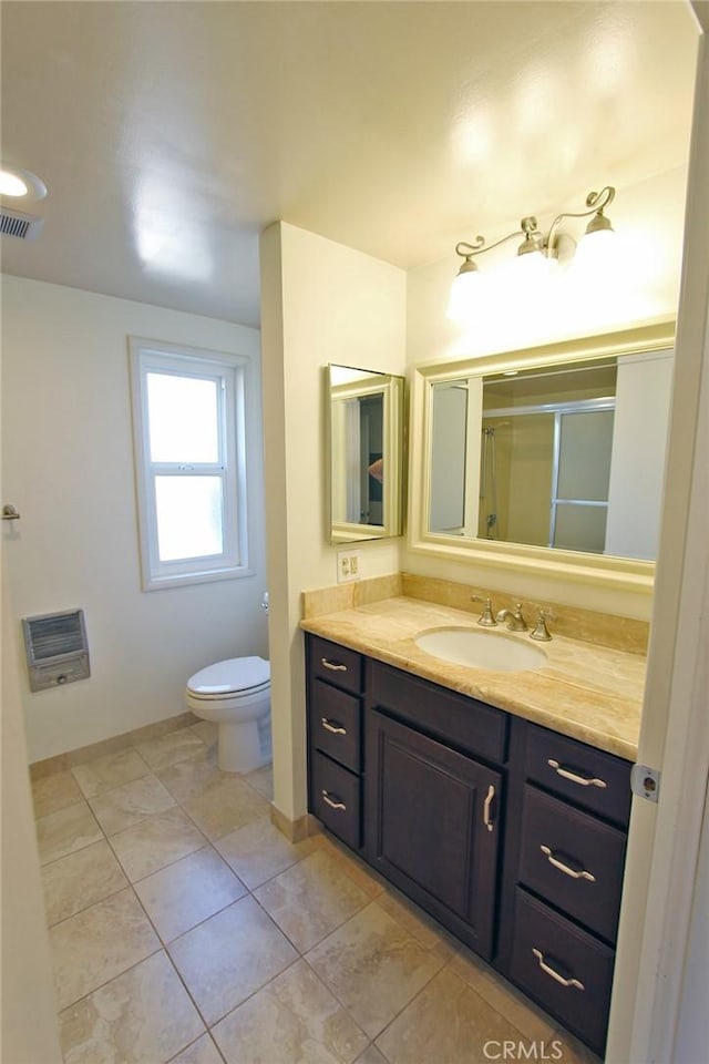 368 Avenida Castilla Unit C, Laguna Woods, CA 92637 - bathroom with vanity, toilet, an enclosed shower, tile patterned flooring, and baseboards