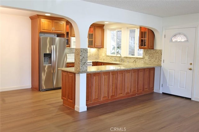 368 Avenida Castilla Unit C, Laguna Woods, CA 92637 - kitchen with stainless steel fridge, light stone counters, wood finished floors, a sink, and a textured ceiling