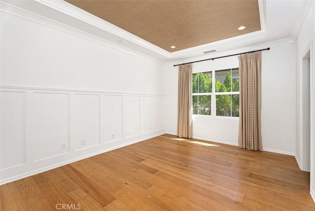 104 Working, Irvine, CA 92602 - unfurnished room featuring a decorative wall, ornamental molding, a raised ceiling, light wood-type flooring, and recessed lighting
