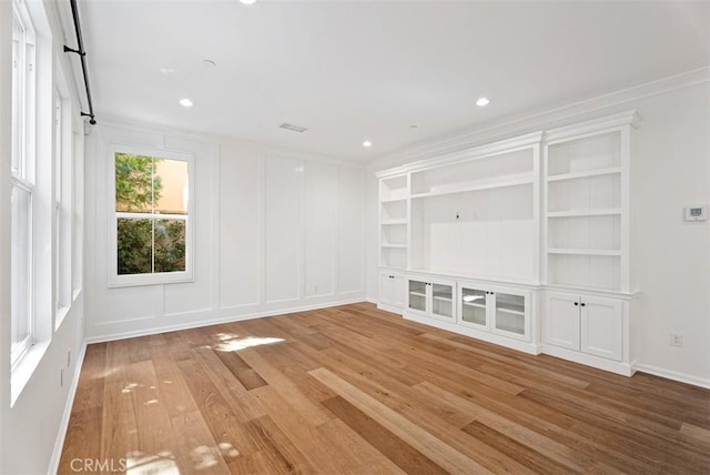 104 Working, Irvine, CA 92602 - unfurnished room featuring light wood-style flooring, crown molding, a decorative wall, and recessed lighting