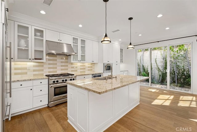104 Working, Irvine, CA 92602 - kitchen with stainless steel range, under cabinet range hood, a sink, wood finished floors, and white cabinetry