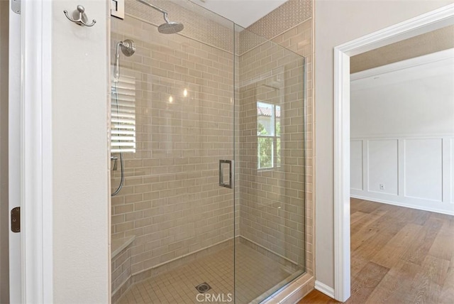 104 Working, Irvine, CA 92602 - bathroom with a shower stall, wood finished floors, a decorative wall, and wainscoting