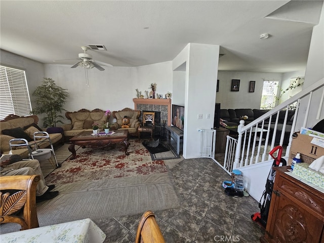 12912 Newport St, Hesperia, CA 92344 - living area featuring a ceiling fan, a fireplace, and stairs
