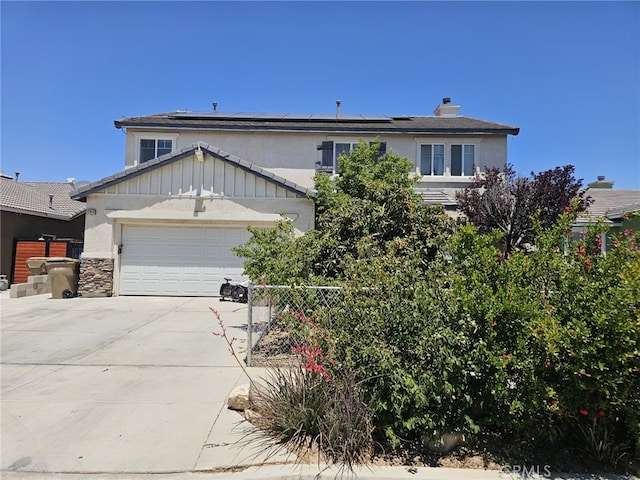12912 Newport St, Hesperia, CA 92344 - view of front of house featuring concrete driveway, roof mounted solar panels, a garage, and stucco siding
