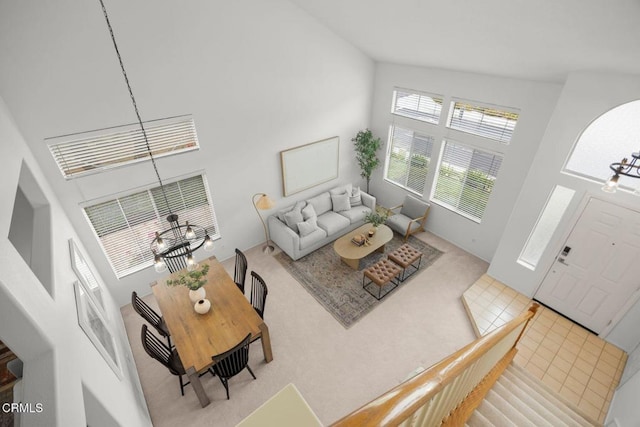 15254 Alyssas Ct, Moorpark, CA 93021 - living area featuring a towering ceiling, carpet floors, and a chandelier
