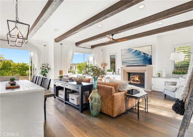 101 Via Almodovar, San Clemente, CA 92672 - living area with beamed ceiling, a glass covered fireplace, hardwood / wood-style floors, a chandelier, and recessed lighting