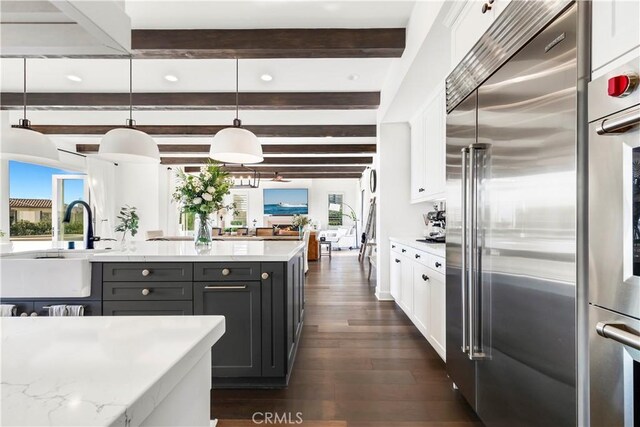 101 Via Almodovar, San Clemente, CA 92672 - kitchen with high quality fridge, beam ceiling, dark wood-style floors, healthy amount of natural light, and white cabinetry