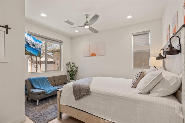 80281 Redstone Way, La Quinta, CA 92253 - bedroom featuring a barn door, recessed lighting, a ceiling fan, and baseboards