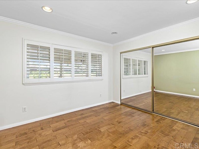 1051 La Reina, San Marcos, CA 92078 - unfurnished bedroom with wood finished floors, crown molding, baseboards, a closet, and recessed lighting