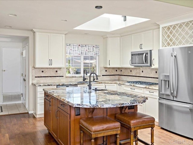 1051 La Reina, San Marcos, CA 92078 - kitchen with stainless steel appliances, a sink, an island with sink, white cabinets, and recessed lighting